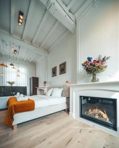 a bedroom with a bed and a fireplace at B&B Barabas in Bruges