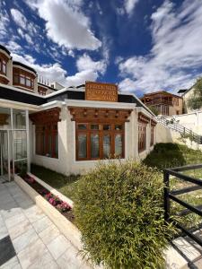 a house with a fence in front of it at Hotel New Glacier View in Leh