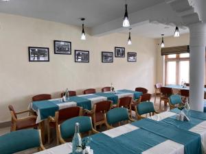 a row of tables and chairs in a room at Hotel New Glacier View in Leh