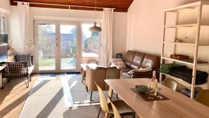 a living room with a table and a couch at Ferienhaus Seeblick in Breitenbrunn