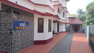 a building with a sign on the side of it at KMH RESIDENCY in Payyannūr
