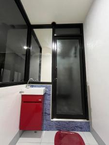 a bathroom with a red sink and a shower at Malaran Guest House in Larena +17 photos