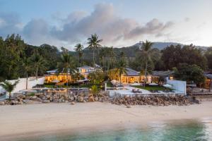 an aerial view of a resort on the beach at Lotus Samui Luxury Beach Villas in Mae Nam