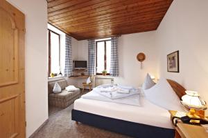 ein Schlafzimmer mit einem Bett und ein Wohnzimmer in der Unterkunft Hotel Drei Mohren in Garmisch-Partenkirchen