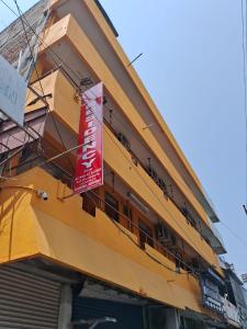 un edificio amarillo con un cartel en el costado en cg residency en Pondicherry