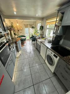 a kitchen with a sink and a dishwasher at My Sky LDN Secret Garden in London