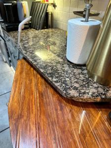 a kitchen counter with a sink and a counter top at My Sky LDN Secret Garden in London