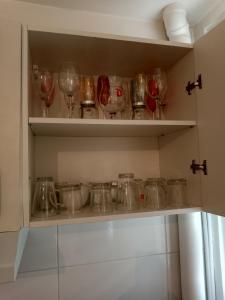 a bunch of wine glasses sitting on a shelf at Joli in Clichy