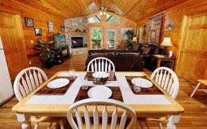 a dining room with a wooden table and chairs at Dogwood Acres in Pigeon Forge