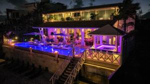 a house with a swimming pool at night at Villa Sha - Cancun Luxury Beachfront in Cancún
