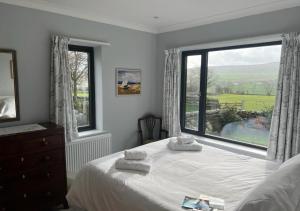 a bedroom with a bed and a large window at Heathlands in Carlton