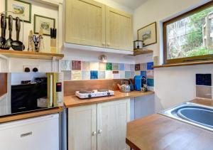 a kitchen with a sink and a counter top at Dart View Cabin in Totnes