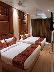 a hotel room with two beds in a room at Hotel JR Grand 100 Meter From Golden Temple in Amritsar