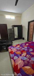 a room with a colorful blanket on the floor at Shri mallick Mangalam in Korba