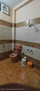 a bathroom with a toilet and a shower at Shri mallick Mangalam in Korba