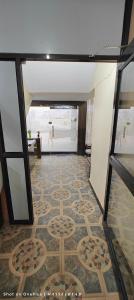 a room with a tile floor with a design on it at Shri mallick Mangalam in Korba