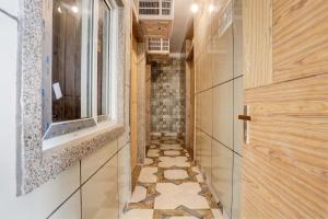 a hallway with a tile floor and a window at Hotel O 7 in Lucknow