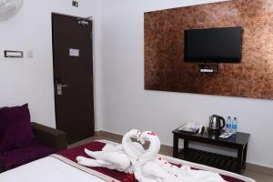 Postel nebo postele na pokoji v ubytování CS Arunachala Residency