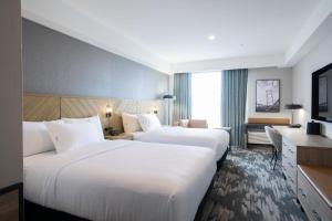 Postelja oz. postelje v sobi nastanitve Sandman Signature Dartmouth Hotel & Suites