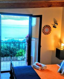 a bedroom with a bed and a view of the ocean at B&B Le Anthos in Marina di Camerota