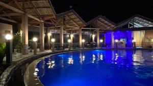 a swimming pool at night with blue lights at Annabel's Resort in Ferrol