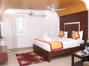 Postel nebo postele na pokoji v ubytování CS Arunachala Residency