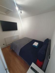 a bedroom with a bed and a television and a desk at tranquility in Enfield