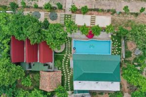 an overhead view of a building with a swimming pool at Restful River Villas in Phong Nha