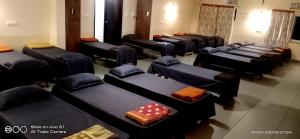 a room with a bunch of beds with dice on them at Sridham in Puri
