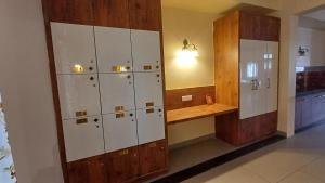 a locker room with white lockers and a wooden counter at Sridham in Puri