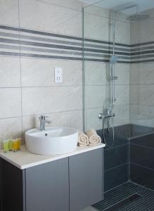 a bathroom with a sink and a shower at Freij Beach Hotel Adults Only in Ayia Napa