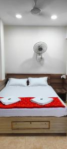a bed with two white towels on top of it at ANDAMAN EXQUISITE in Port Blair