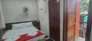 a small bedroom with a bed and a door at ANDAMAN EXQUISITE in Port Blair