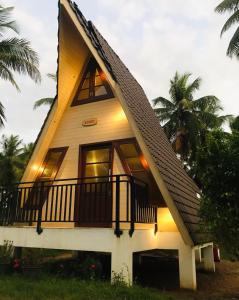 a small house with a gambrel roof at Liverpool Estate - Chilaw in Chilaw
