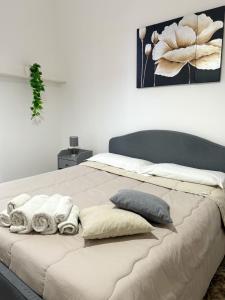 1 dormitorio con 1 cama grande y toallas. en Sant'Oliva28 en Palermo