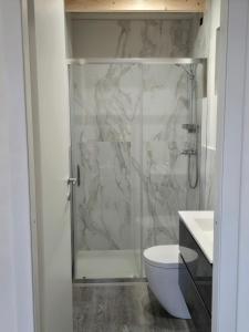 a bathroom with a shower with a toilet and a sink at Campeggio Gianna Golfo dei Poeti in Lerici