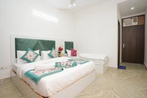 a bedroom with a large white bed in a room at Hotel Diamond Home Stay In Jangpura Bhogal Near Nizamuddin Railway Station in New Delhi