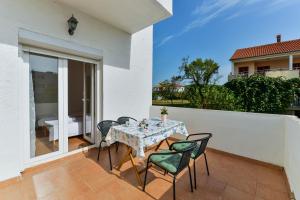 a patio with a table and chairs on a balcony at Apartments Citrus in Turanj