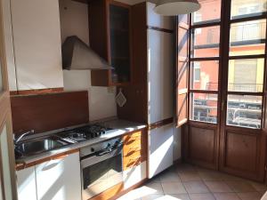 a kitchen with a stove and a sink and a window at Numero 3 in Cagliari