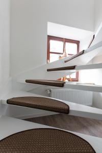 a room with white shelves and a chair at Felsenhäuschen in Monschau
