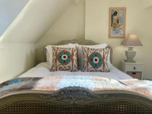 a bedroom with a bed with pillows on it at Fabulous Grade 2 Listed Home in Heart of Stow in Stow on the Wold
