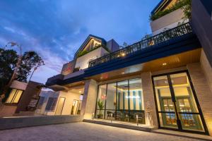 a building with large glass windows and a balcony at ValStar Hotel Canggu in Canggu