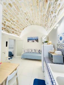 eine Küche und ein Wohnzimmer mit einem Bett im Hintergrund in der Unterkunft BLU MARE suite privata & apartment in Terrasini