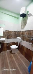 a bathroom with a toilet and a sink at Shiv Niketan Guest House 200mtr from Shri Ram mandir in Ayodhya