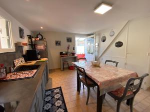 a kitchen and dining room with a table and chairs at Ker Arcadia in Pleurtuit