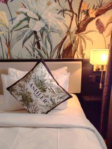 a pillow sitting on top of a bed in a room at The Palm Suite@Chusan in George Town