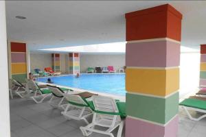 a large swimming pool with chairs and chairs around it at Side Win Hotel & Spa in Side