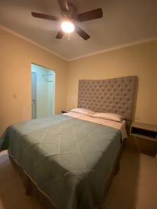 a bedroom with a large bed with a ceiling fan at Departamentos Ada's in Puerto Peñasco