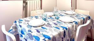 a dining room table with a blue and white table cloth at CASA ELENA- Casa Vacanze nel centro di Sottomarina in Chioggia