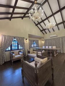 a large living room with couches and a chandelier at The Farmhouse in Ipoh